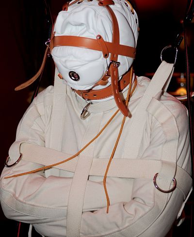 submissive in isolation hood and straightjacket